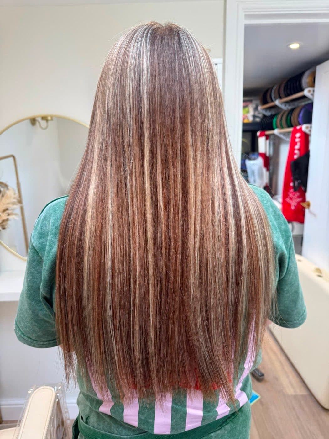 Long hair extensions blended through highlighted blonde and brown hair, photographed in the Stevenage studio